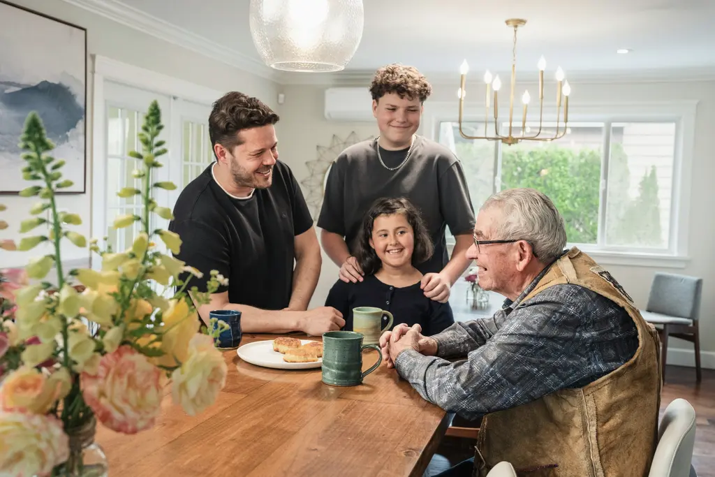 A family around a wooden table with mugs