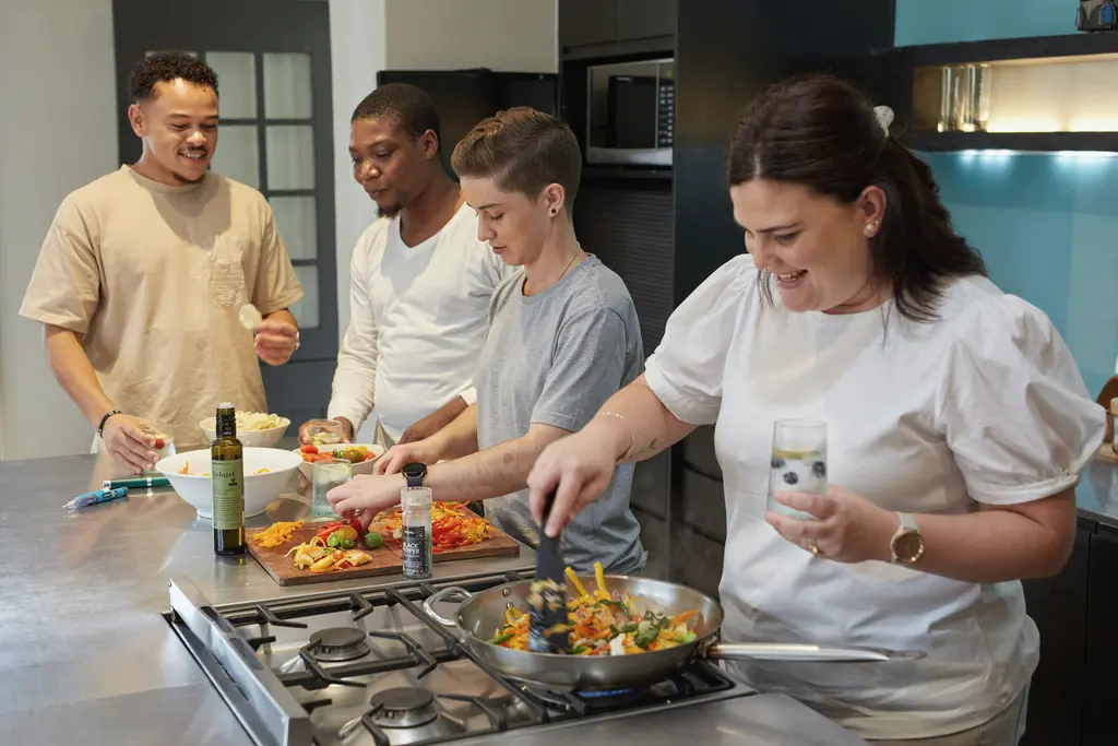 A group preparing a meal together in a kitchen