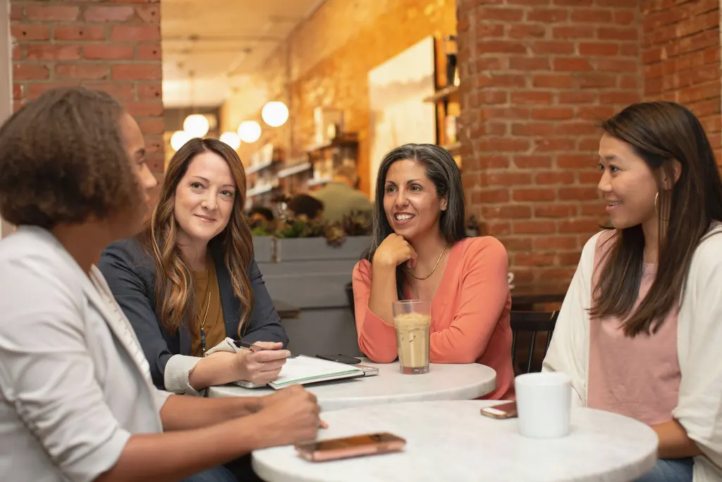 A small group talking around a café table